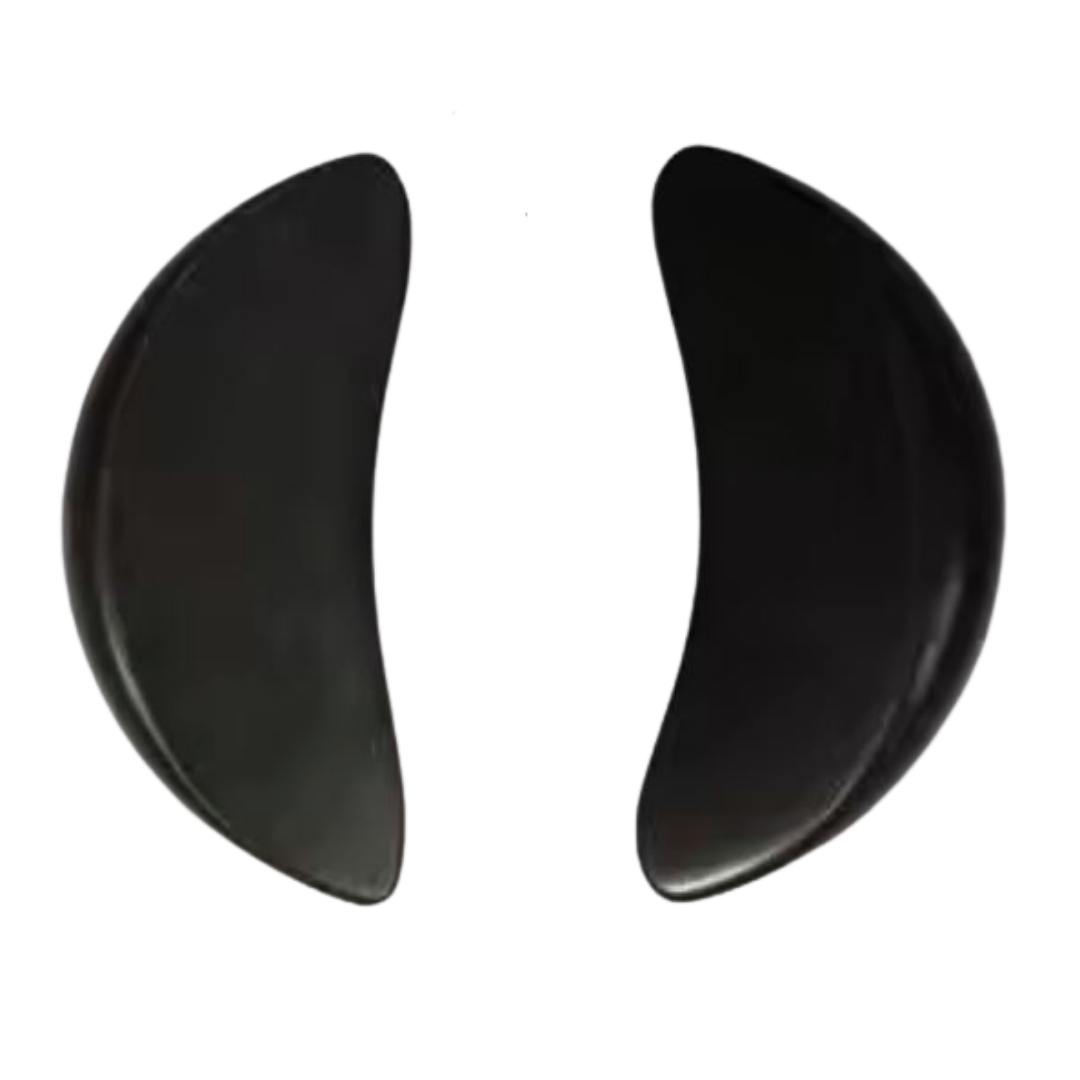 Two black crescent-shaped basalt massage stones shown side by side on a plain white background.