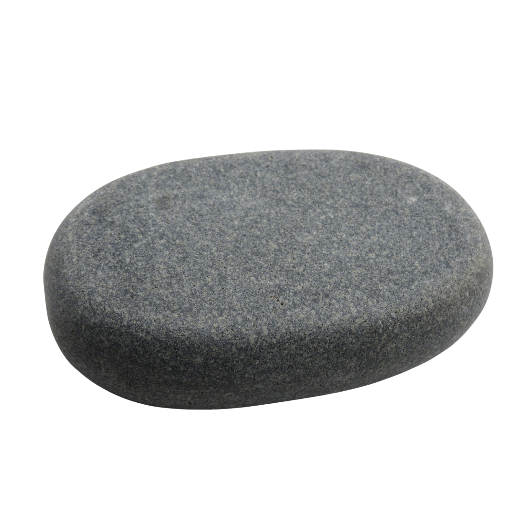 A grey to black placement spa massage stone on white background