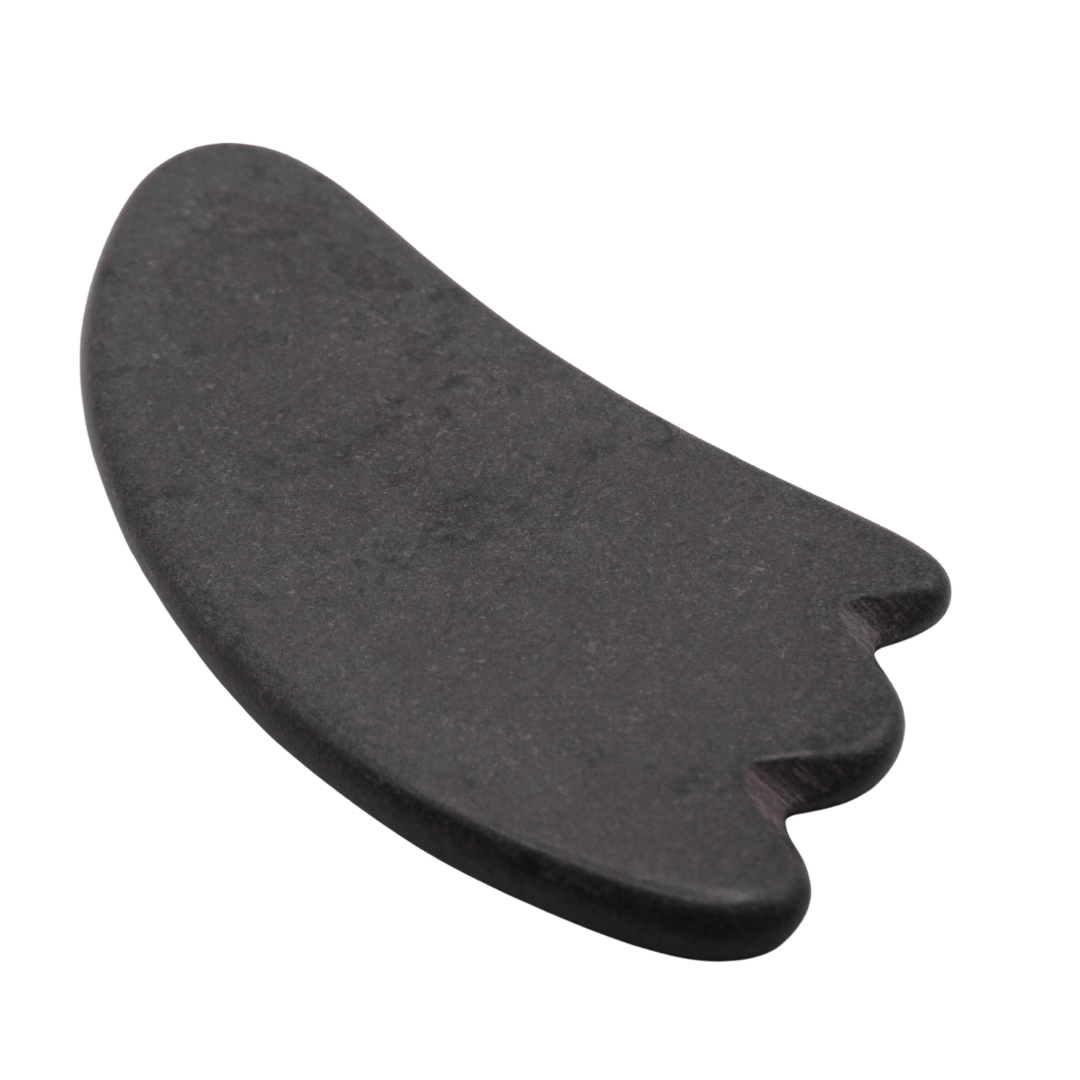 A single black Guasha massage stone with a smooth, polished surface.