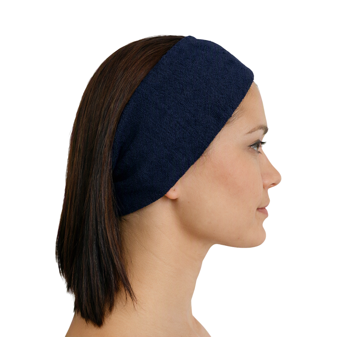 A woman shown in side profile wearing a dark navy blue fabric headband against a plain white background.