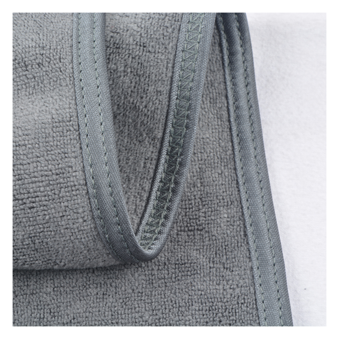 Close-up of a gray textured fabric headband with stitched trim, showing the terry-like material and seam detail against a white background.