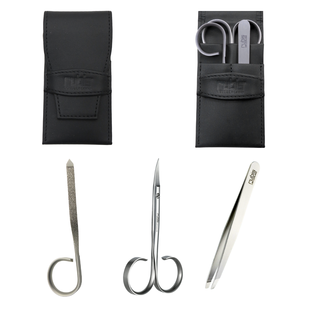 A set of three silver metal beauty tools with black leather storage pouches on a white background. The tools include a curved nail file, small manicure scissors, and tweezers, all branded with the Rubis logo.