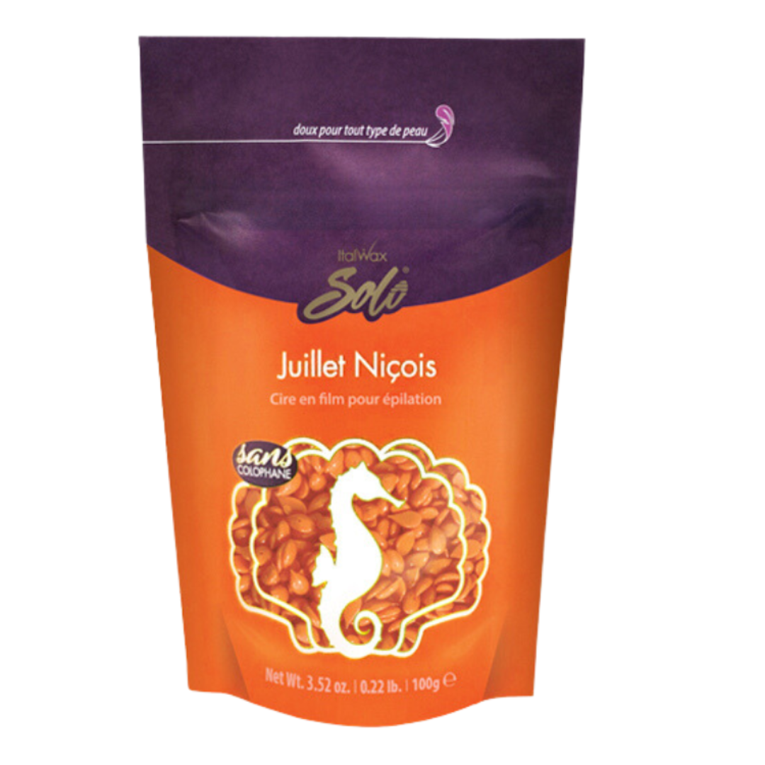 W319B Italwax 100g Synthetic Coral Film Wax | A bag of orange Italwax Coral film wax, in an orange and purple bag branded with Italwax Solo Julier Nicois with bright orange wax beads showing through