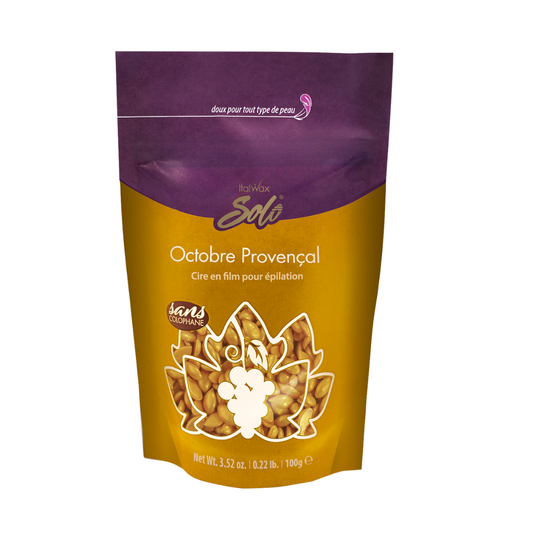 W323B Italwax Full Body Film Wax | A stand-up 100g pouch of Italwax Solo Octobre Provençal hot film wax, featuring a purple top section and a golden-yellow bottom section with a clear window showing the gold film wax granules inside.