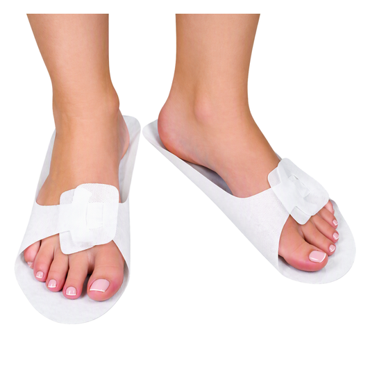 White open-toe slide slippers shown on a person's feet against a plain white background.