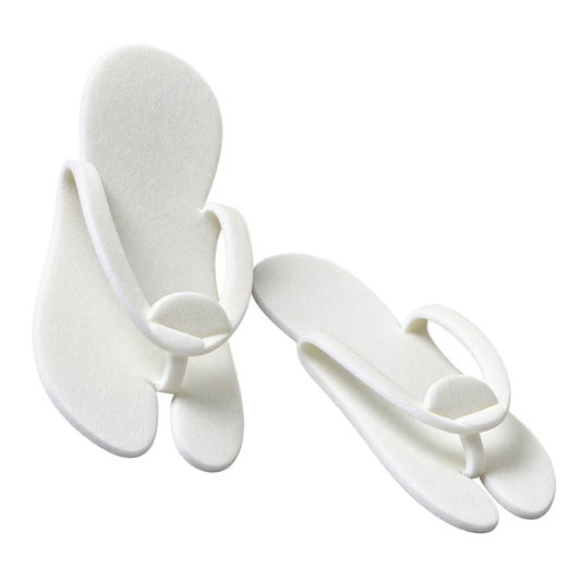 A pair of white foam flip-flop sandals with wide, thick straps, shown on a plain white background.