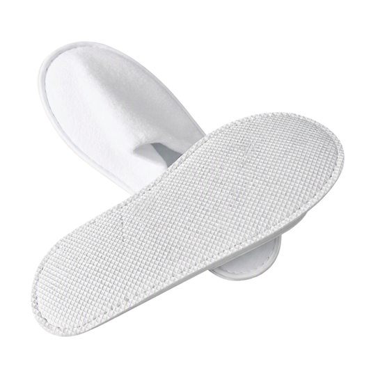 A pair of white non-slip slippers with textured grip soles, shown on a clean white background.