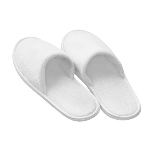 A pair of white plush bath slippers on a solid white background.