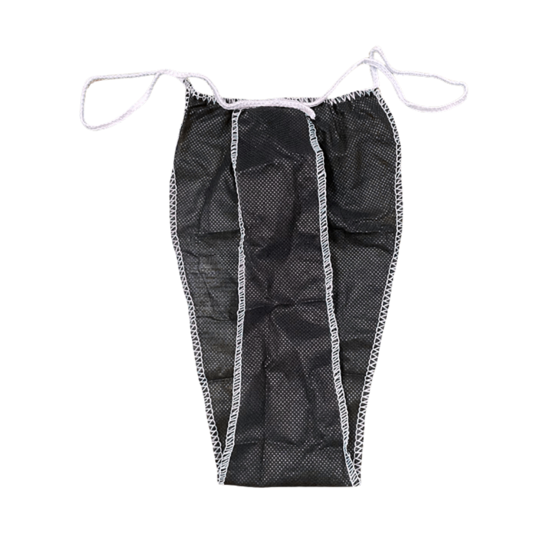 Z702E Disposable Waxing Body wrap G-string | A black disposable non-woven thong with white elastic and white zigzag trim, shown flat against a white background.