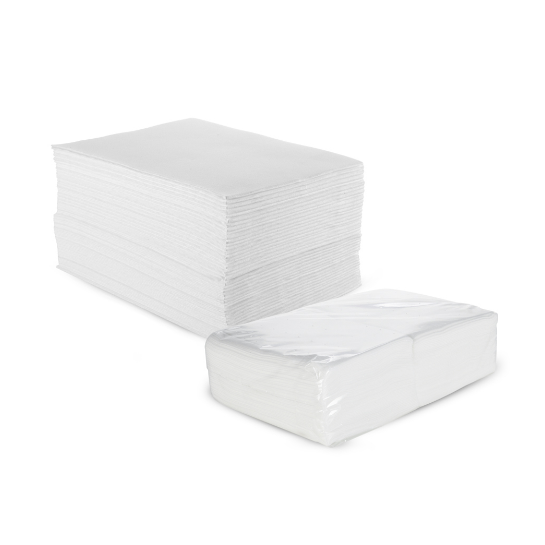 Z711A Disposable Dry Paper Towel | A bulk pack of white disposable towels, with one large stack standing in the back and one smaller stack wrapped in clear plastic in the front, on a white background.