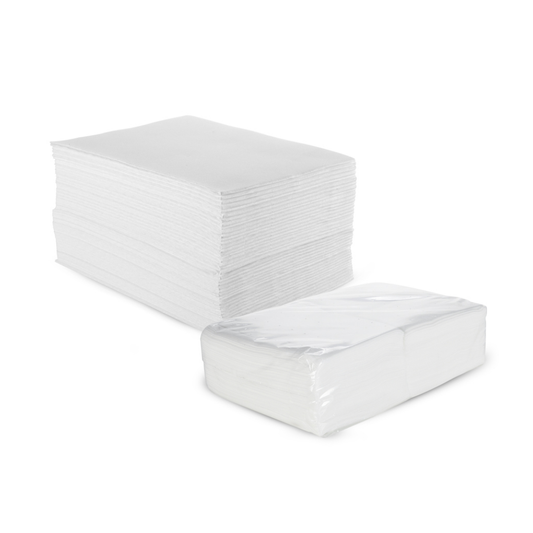 Z711A Disposable Dry Paper Towel | A bulk pack of white disposable towels, with one large stack standing in the back and one smaller stack wrapped in clear plastic in the front, on a white background.
