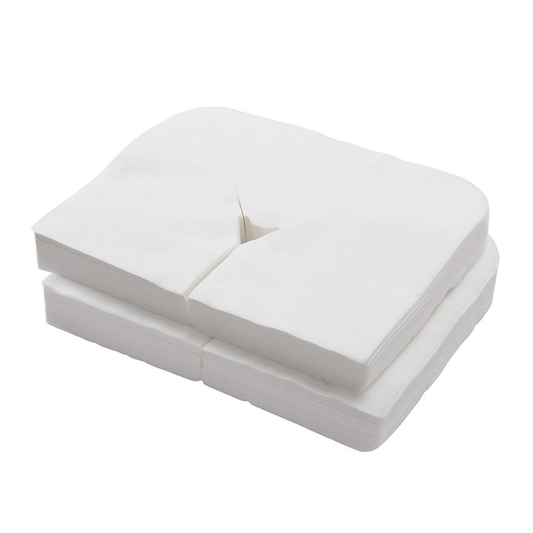 Z713B White Disposable Massage Bed Face Hole Cover 100pack | A stack of white non-woven rectangular sheets with rounded corners and a central split crease on the top piece, photographed on a plain white background.