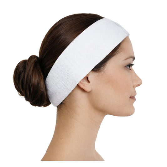 A white stretch disposable headband worn by a model with her hair in a low bun, shown in profile against a plain white background.