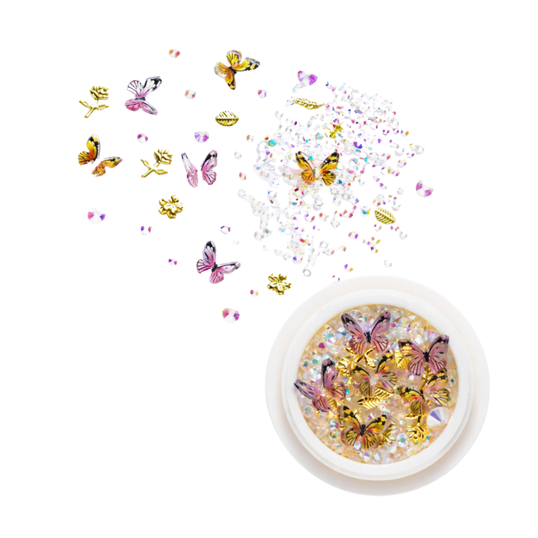 A round pot of 3D nail art rhinestones, gems and butterflies with loose ones in the background