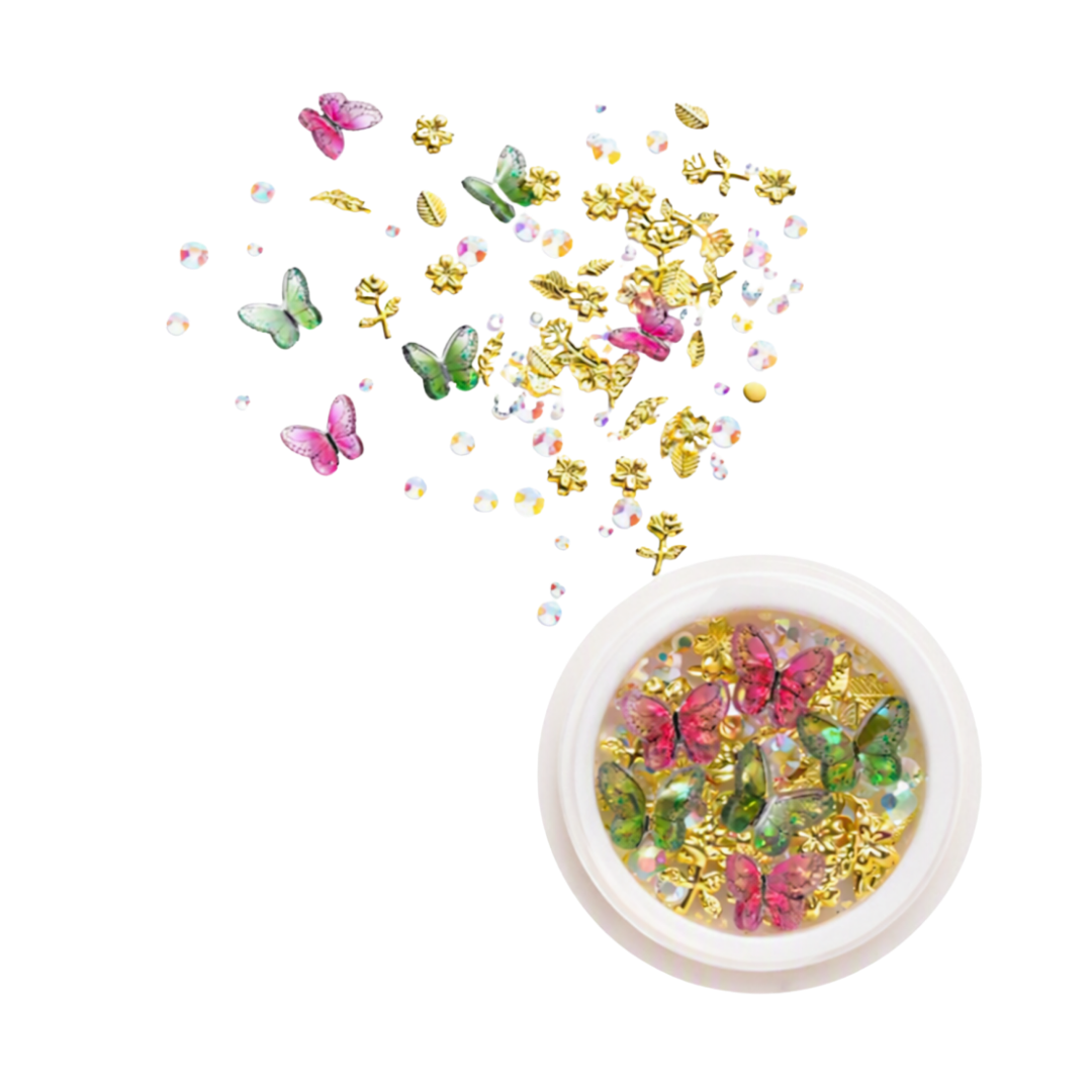 A round pot of 3D nail art rhinestones, gems and butterflies with loose ones in the background