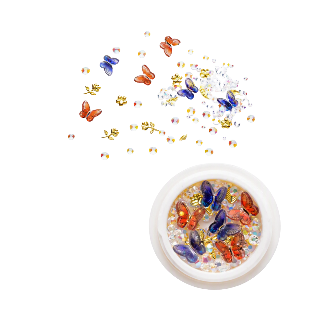 A round pot of 3D nail art rhinestones, gems and butterflies with loose ones in the background