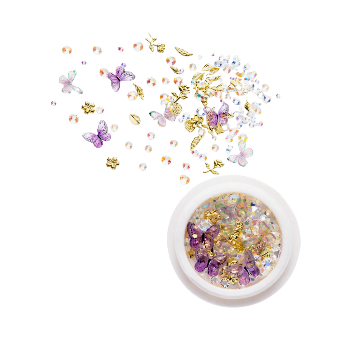 A round pot of 3D nail art rhinestones, gems and butterflies with loose ones in the background