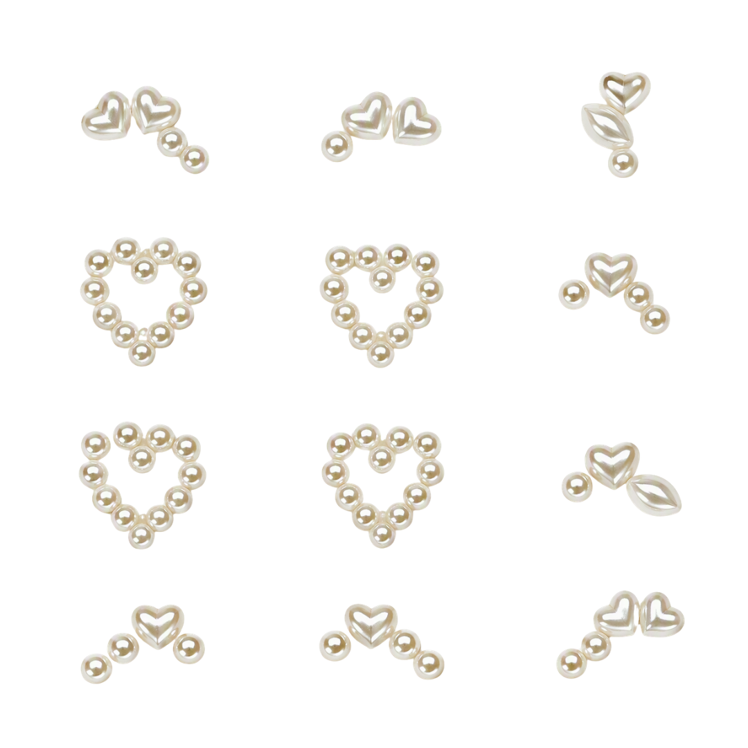 Twelve small heart-shaped nail art beads arranged in a 3x4 grid on a plain white background. The pieces are metallic with a warm champagne or pale gold tone, and some include tiny pearl-like round accents.