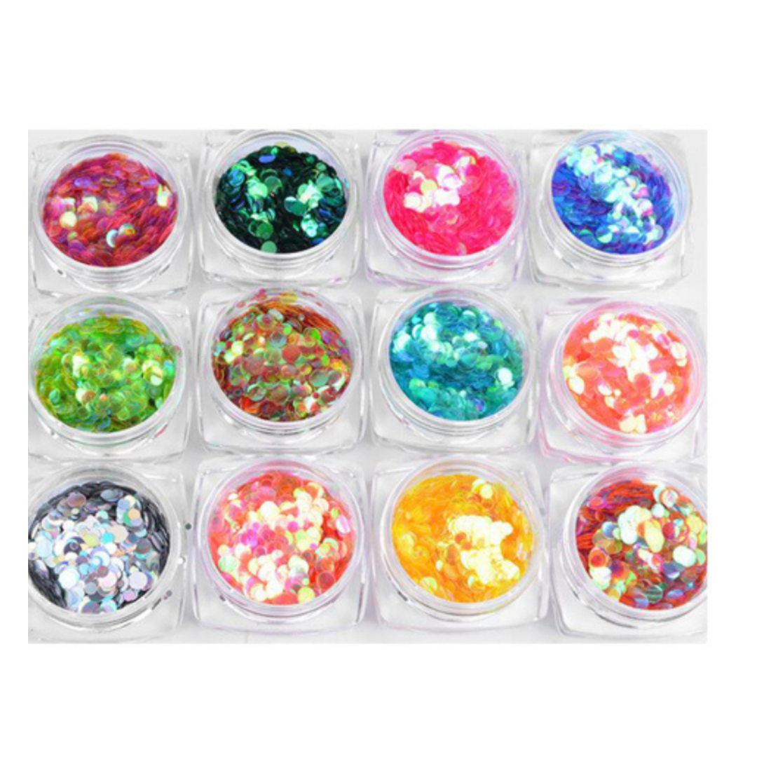 Twelve small clear plastic jars arranged in a 3-by-4 grid, each filled with multicolored iridescent nail art sequins or glitter in different bright shades including pink, blue, green, orange, yellow, red, and silver.