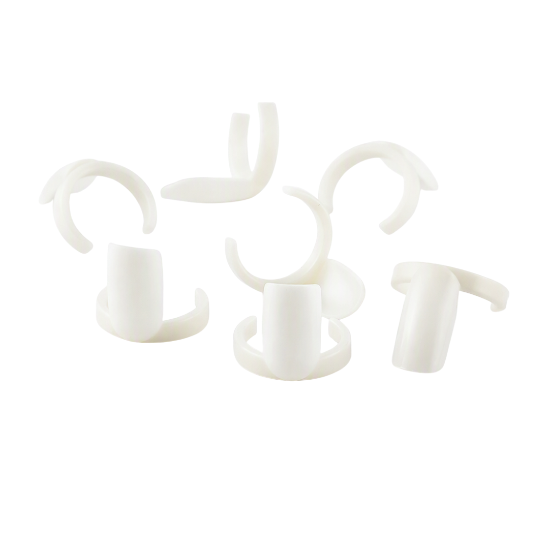 Six small white plastic hook-like nail art display rings, to fit onto nail polish bottles, arranged on a plain white background.