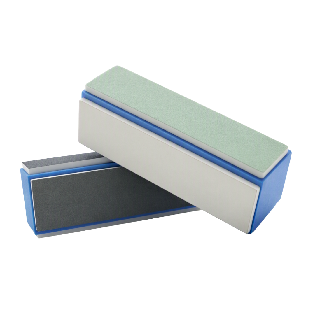 Two rectangular green nail shiner blocks stacked and overlapping on a plain white background. The top file has a pale mint green abrasive surface with a blue edge, and the bottom file has a dark gray abrasive surface with a blue edge.