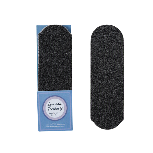 Two black textured nail grit pads for stainless steel foot file shown on a white background, with one file in its blue branded packaging and one loose.