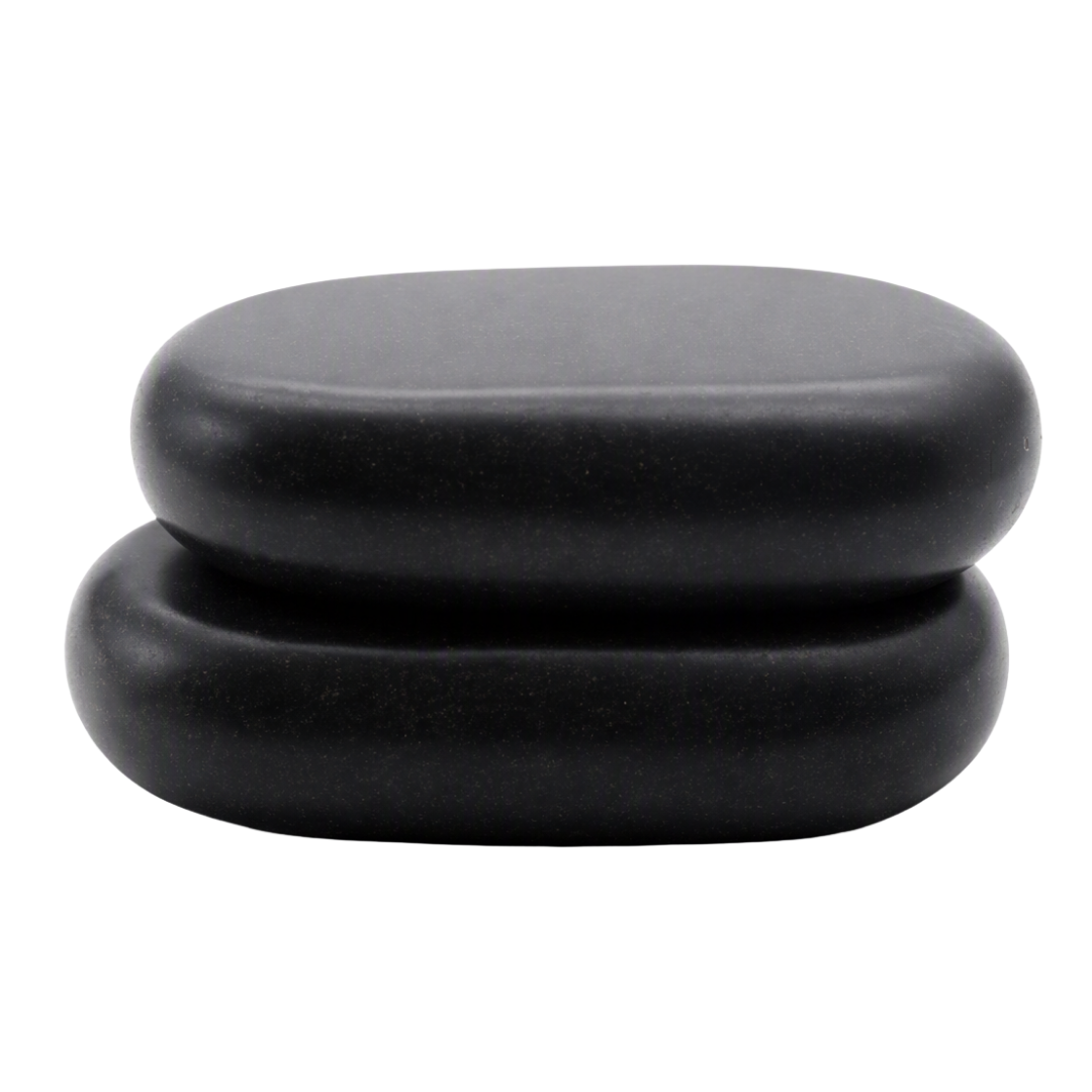 Two smooth, rounded black hot massage stones stacked vertically on a plain white background.
