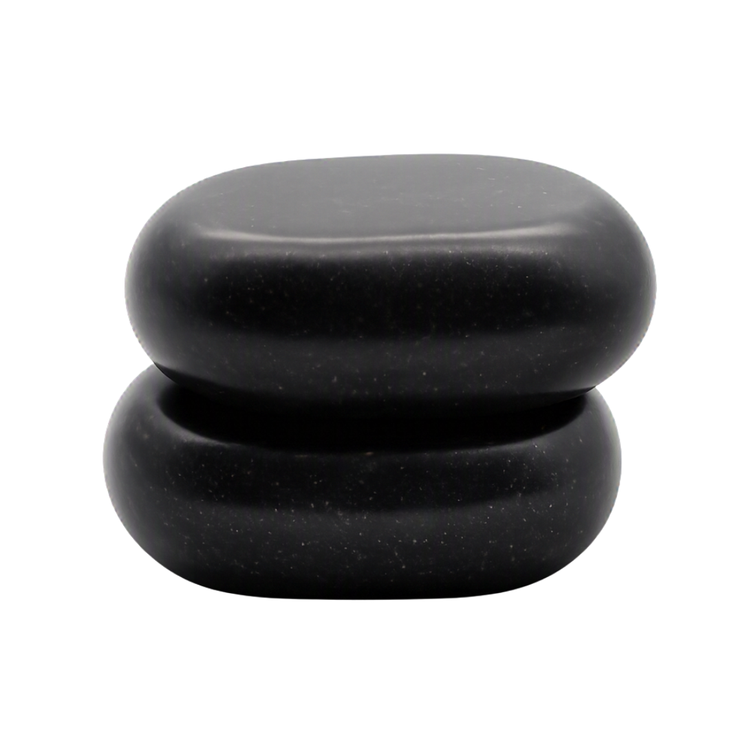 Two smooth black spa stones stacked vertically on a plain white background.