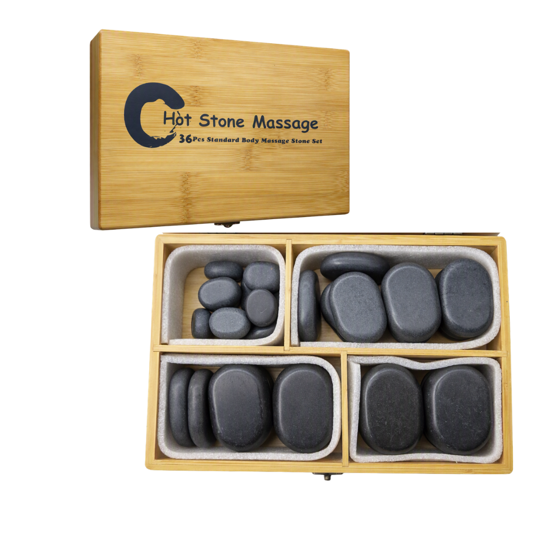 A hot stone massage set in a light bamboo box, shown both closed with the lid printed 'Hot Stone Massage' and open with four compartments holding smooth dark gray stones on a white background.