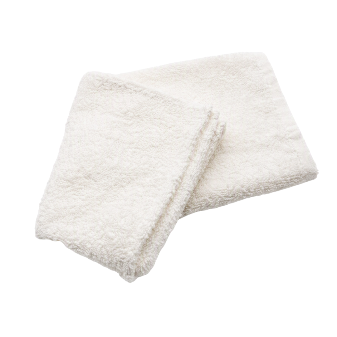 A folded white towel with a soft, plush terry cloth texture, stacked on a solid white background.