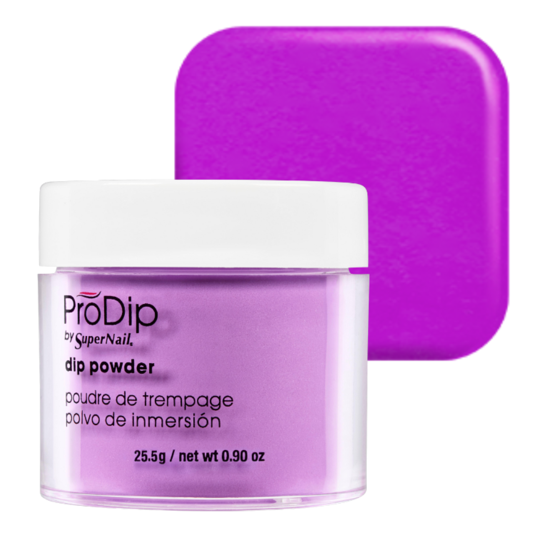 A jar of ProDip by SuperNail acrylic dipping powder in a vibrant purple shade, shown with a matching purple color swatch card in the background on a white studio backdrop.