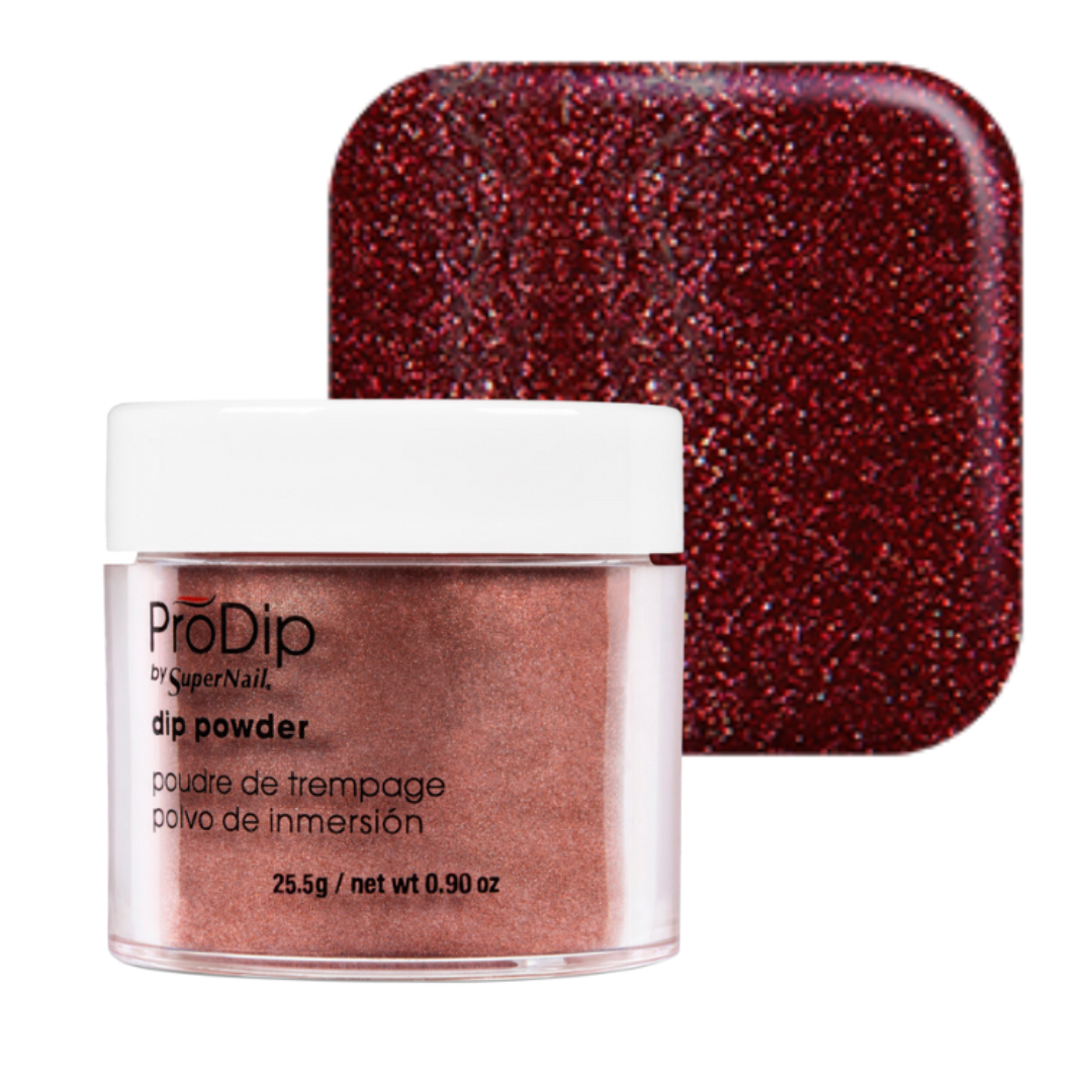 A jar of ProDip acrylic dipping powder with a white lid and clear container showing rose gold metallic powder, alongside a square swatch of the same glittery rose gold color on a white background.