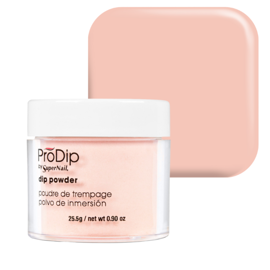 A jar of ProDip by SuperNail dip powder in a soft peach-pink shade, shown in front of a matching square color swatch on a white background.