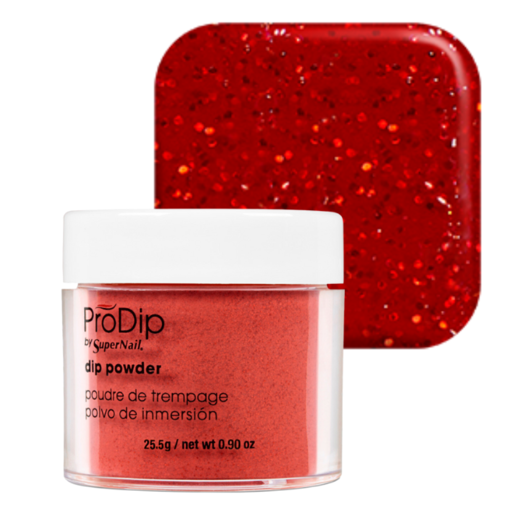 A jar of ProDip SuperNail acrylic dipping powder in a vibrant red glitter shade, shown in front of a matching square swatch of the glittery red powder on a white background.