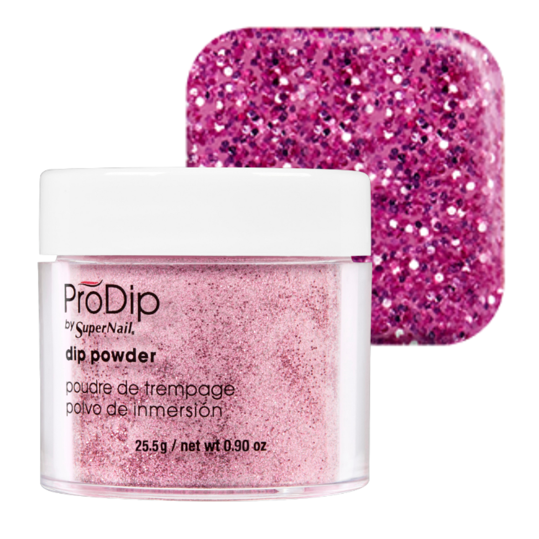 A jar of ProDip by SuperNail acrylic dipping powder with a white lid, shown in front of a square swatch of the same sparkling pink glitter powder on a white background.