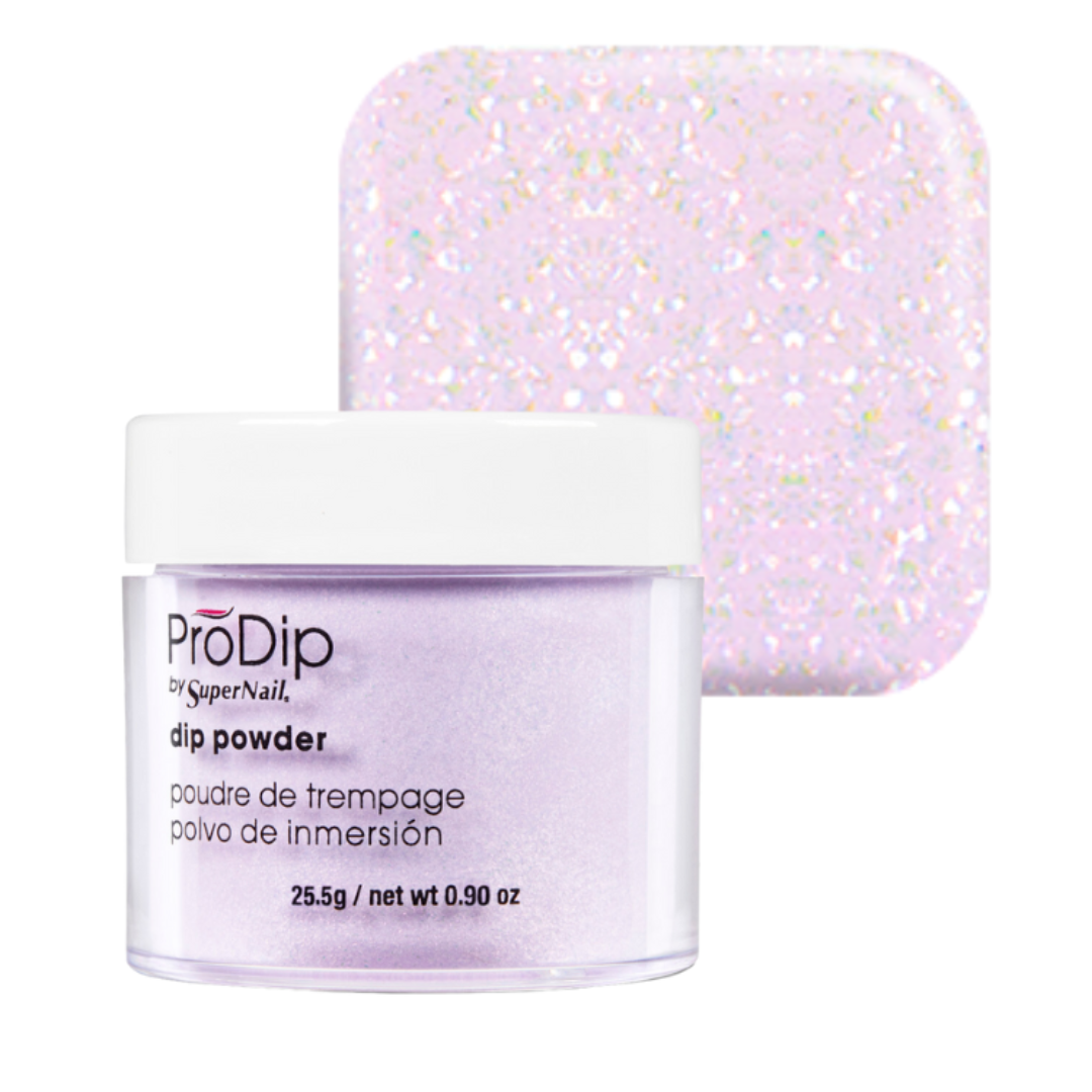 A jar of ProDip SuperNail acrylic dipping powder in a pale lavender color, shown in front of a square swatch displaying the sparkling, holographic finish of the powder.