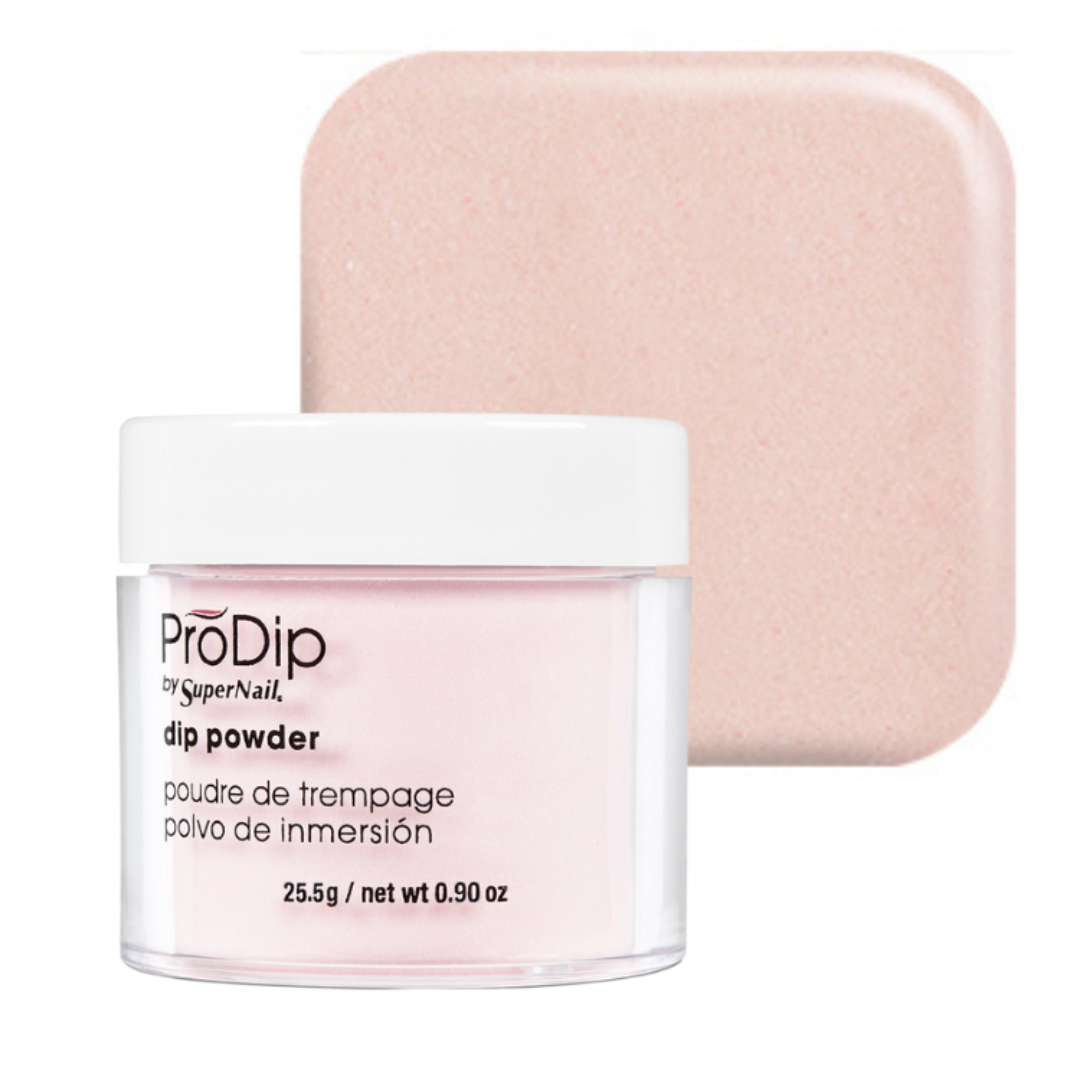 A jar of ProDip by SuperNail acrylic dipping powder in a pale pink shade, shown in front of a matching square swatch of the powder color on a white background.