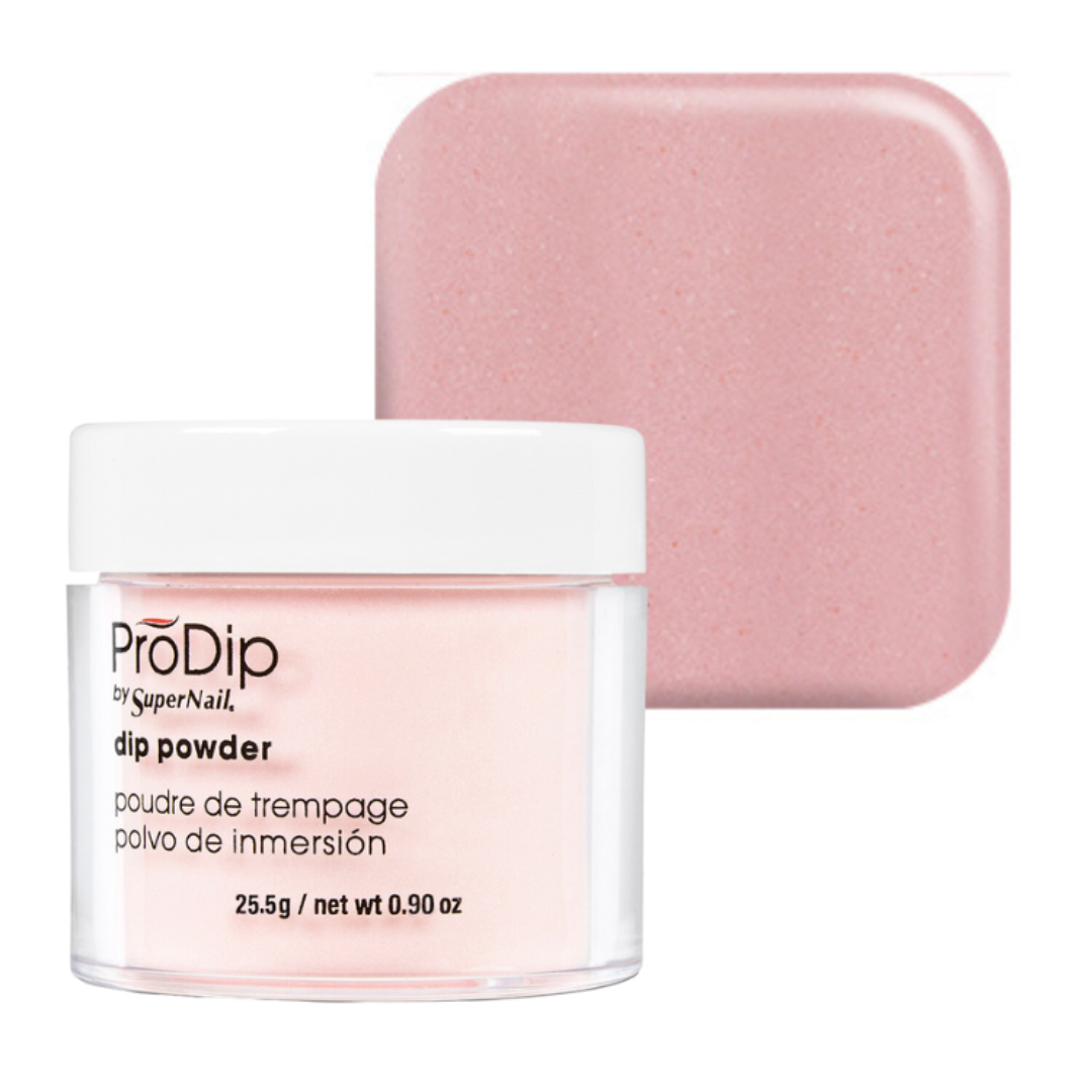 A jar of ProDip by SuperNail acrylic dipping powder with a white lid and clear container, shown in front of a matching dusty pink square swatch on a white background.