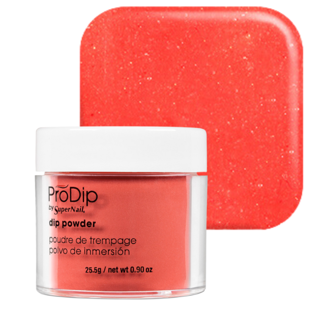 A jar of ProDip by SuperNail dip powder in a bright coral-red shade, shown in front of a matching square color swatch on a white background.