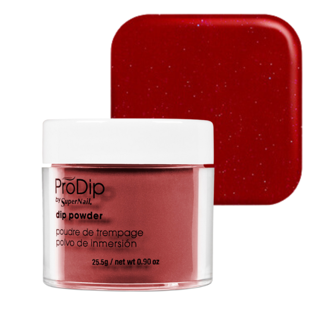 A jar of ProDip by SuperNail acrylic dipping powder in a deep glittery red shade, shown in front of a matching square color swatch on a white background.