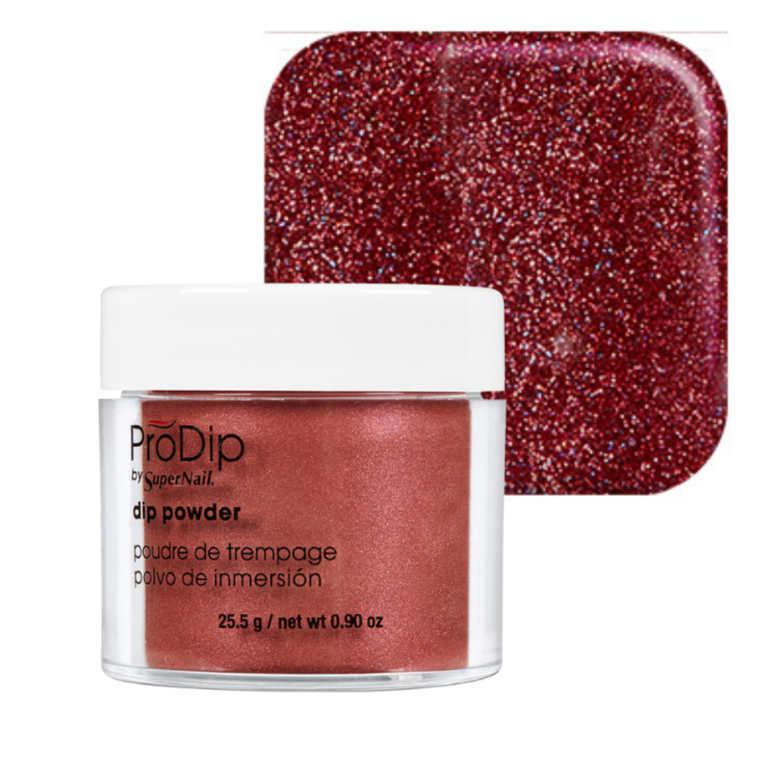 A jar of ProDip by SuperNail acrylic dipping powder in a deep glittery red shade, shown in front of a matching square color swatch on a white background.