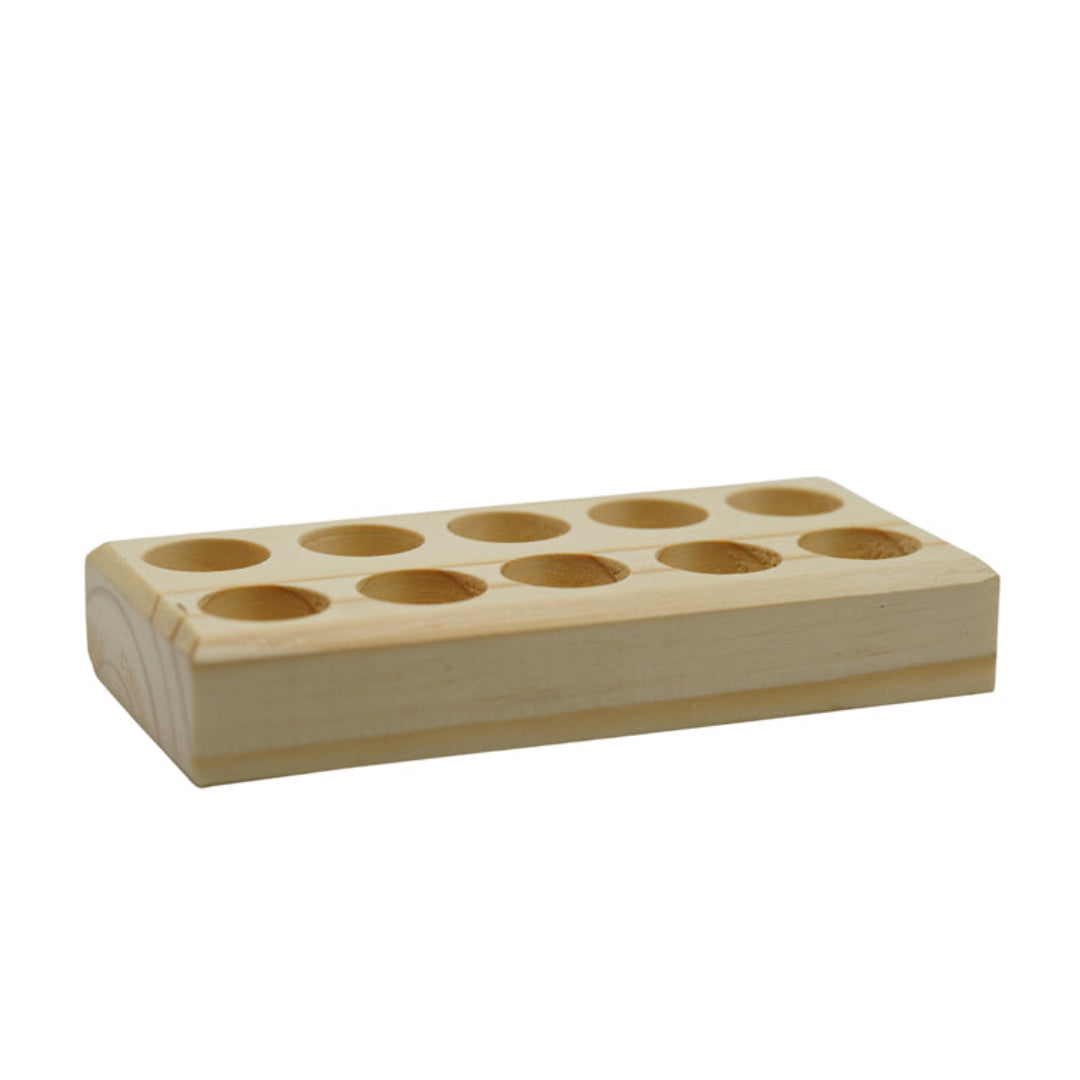 Oblong wooden block with holes for storage of essential oil bottles