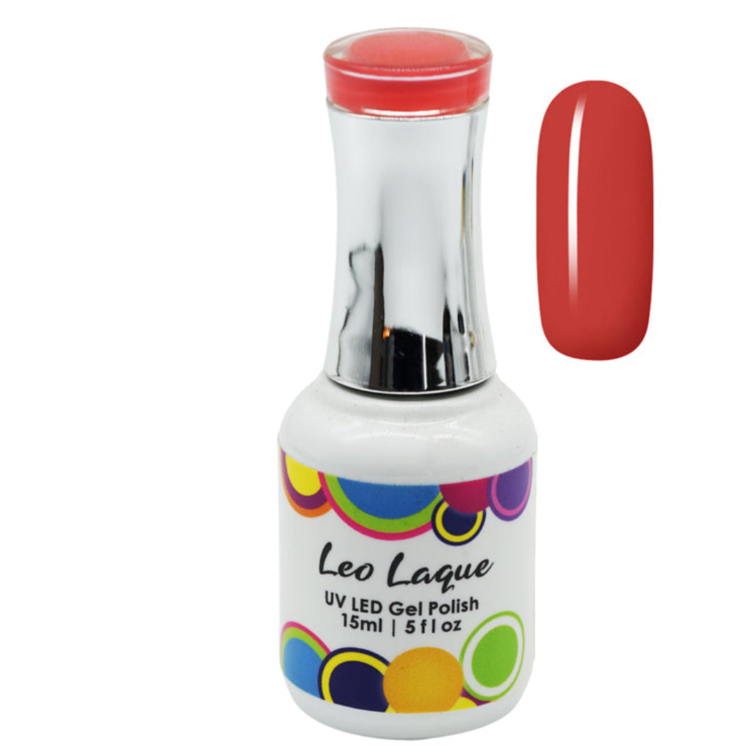 A bottle of Leo Lague UV LED Gel Polish with a white label featuring colorful polka dots, next to a vertical nail swatch showing the coral-red polish color.