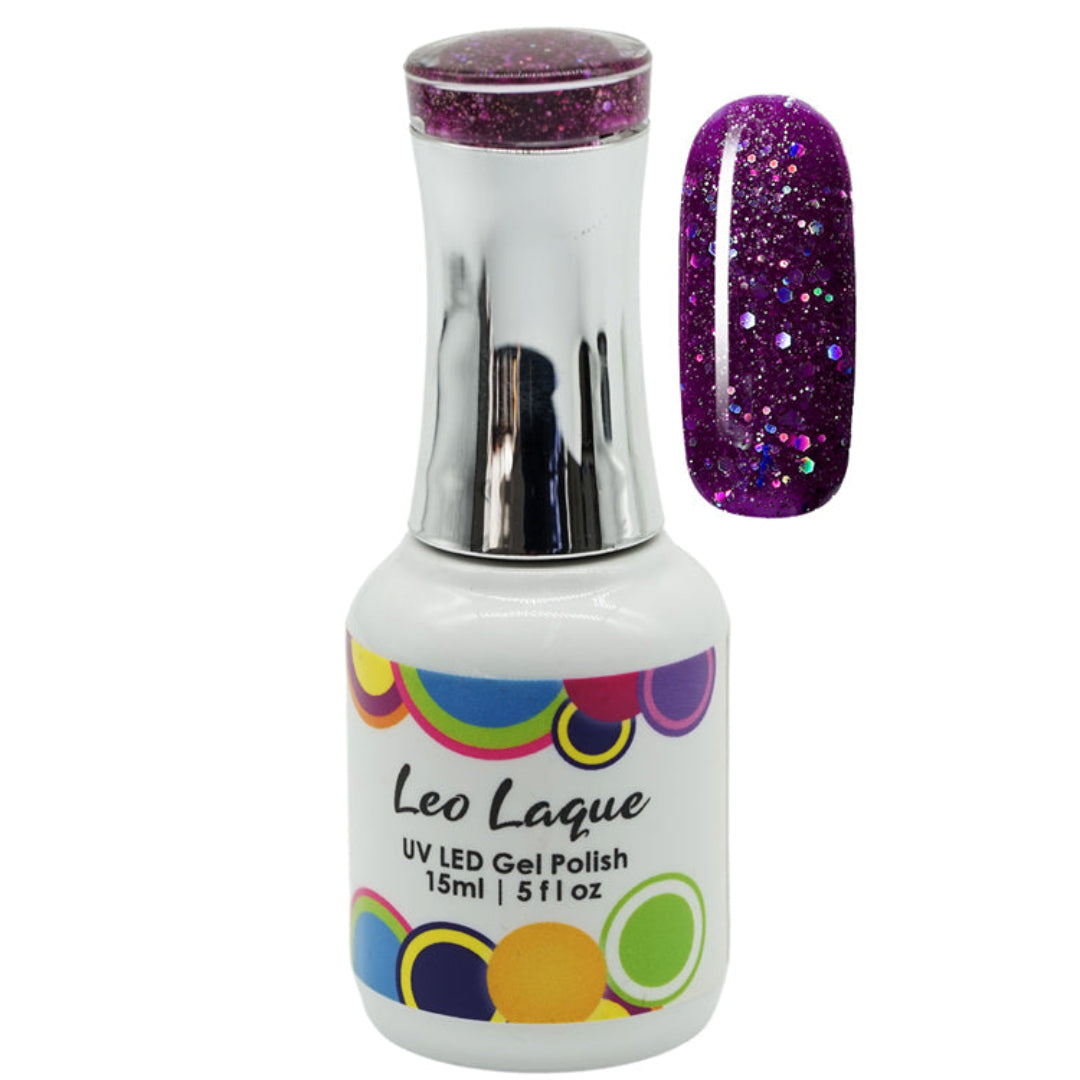 A bottle of Leo Laque UV LED gel nail polish with a silver cap and a white label, shown next to a vertical nail swatch displaying the purple glitter polish.