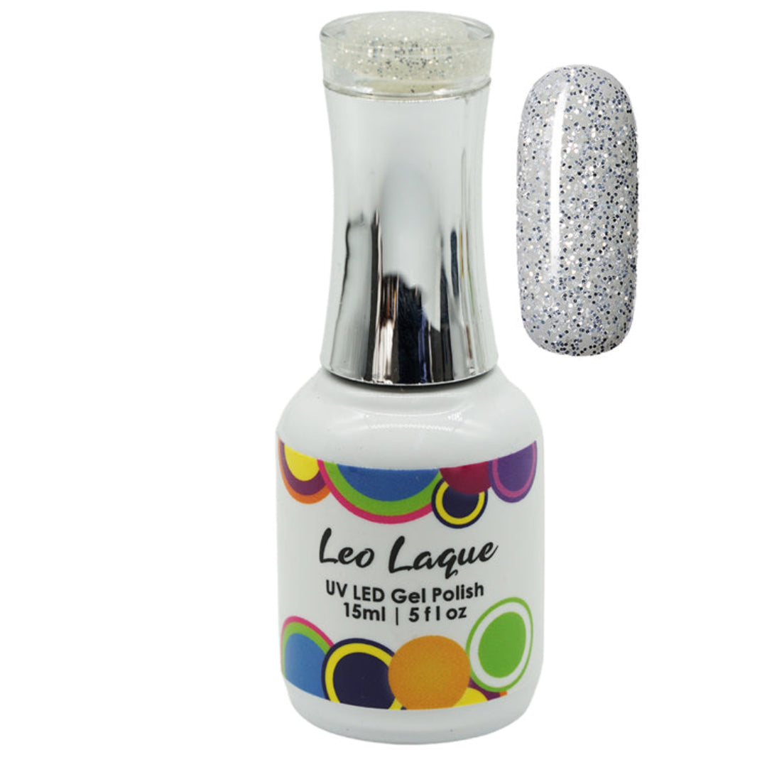 A bottle of Leo Laque UV LED gel polish with a silver cap, shown next to a nail swatch displaying a silver glitter polish.