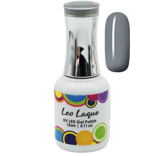 A bottle of Leo Laque UV LED gel polish with a silver cap and a white label featuring colorful circles, shown next to a gray nail swatch on a white background.