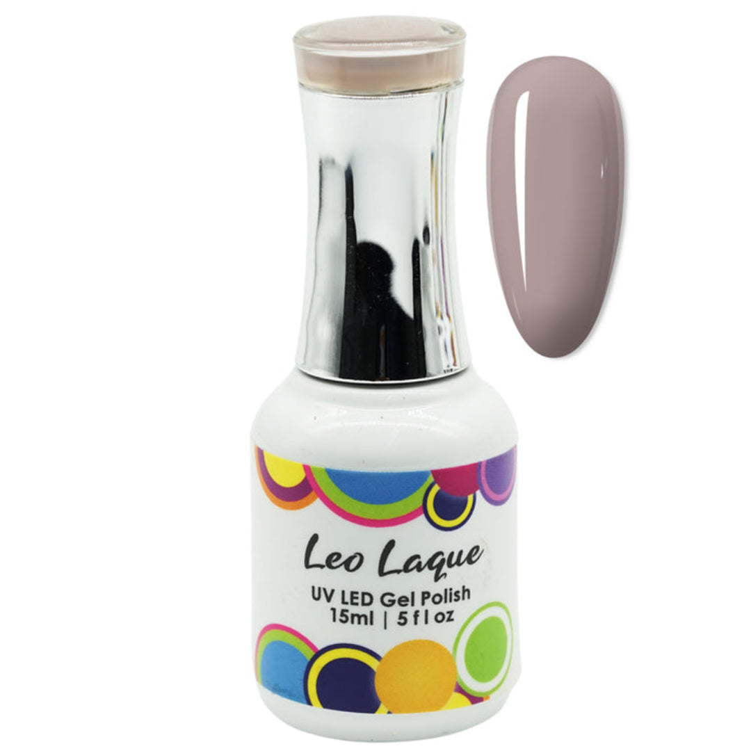 A bottle of Leo Laque UV LED gel nail polish with a metallic silver neck and a white base decorated with colorful circular patterns. A vertical swatch of the polish color is shown to the right of the bottle.