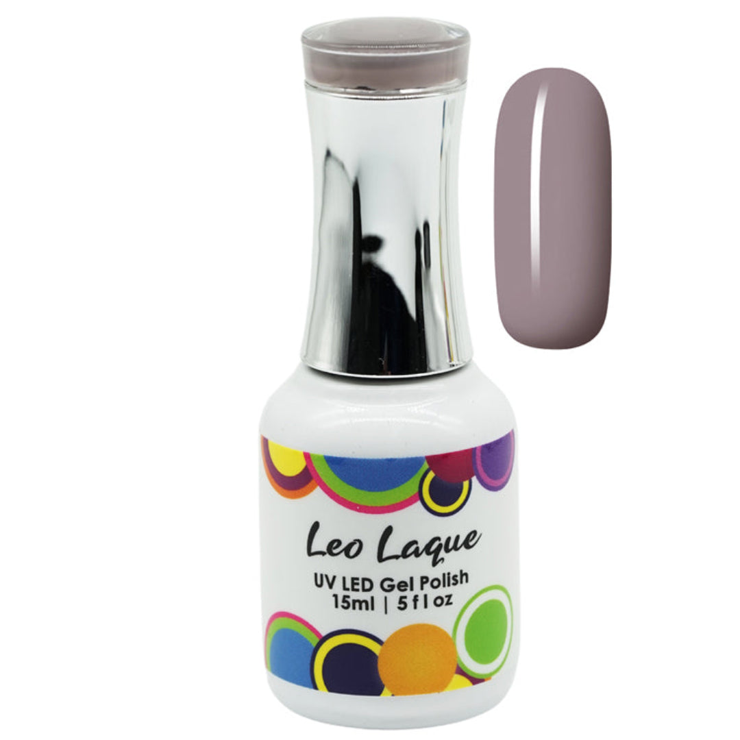 A bottle of Leo Laque UV LED Gel Polish with a metallic silver cap and a white label decorated with colorful circles. Next to the bottle is a vertical nail color swatch showing a dusty mauve-purple shade.