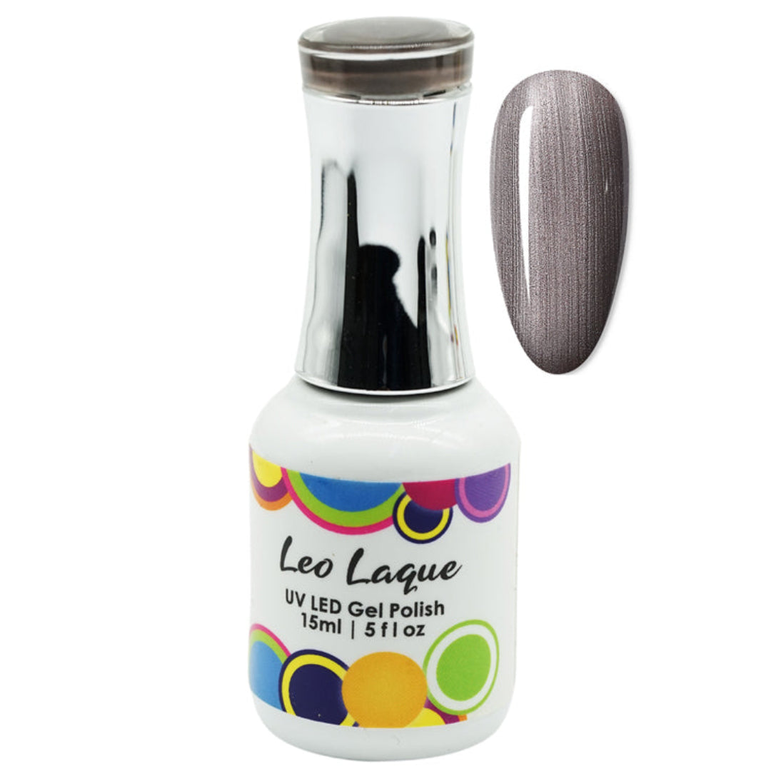 A bottle of Leo Laque UV LED gel polish with a metallic silver cap and a white label featuring colorful circles, shown next to a nail swatch displaying a shimmering gray-brown polish.