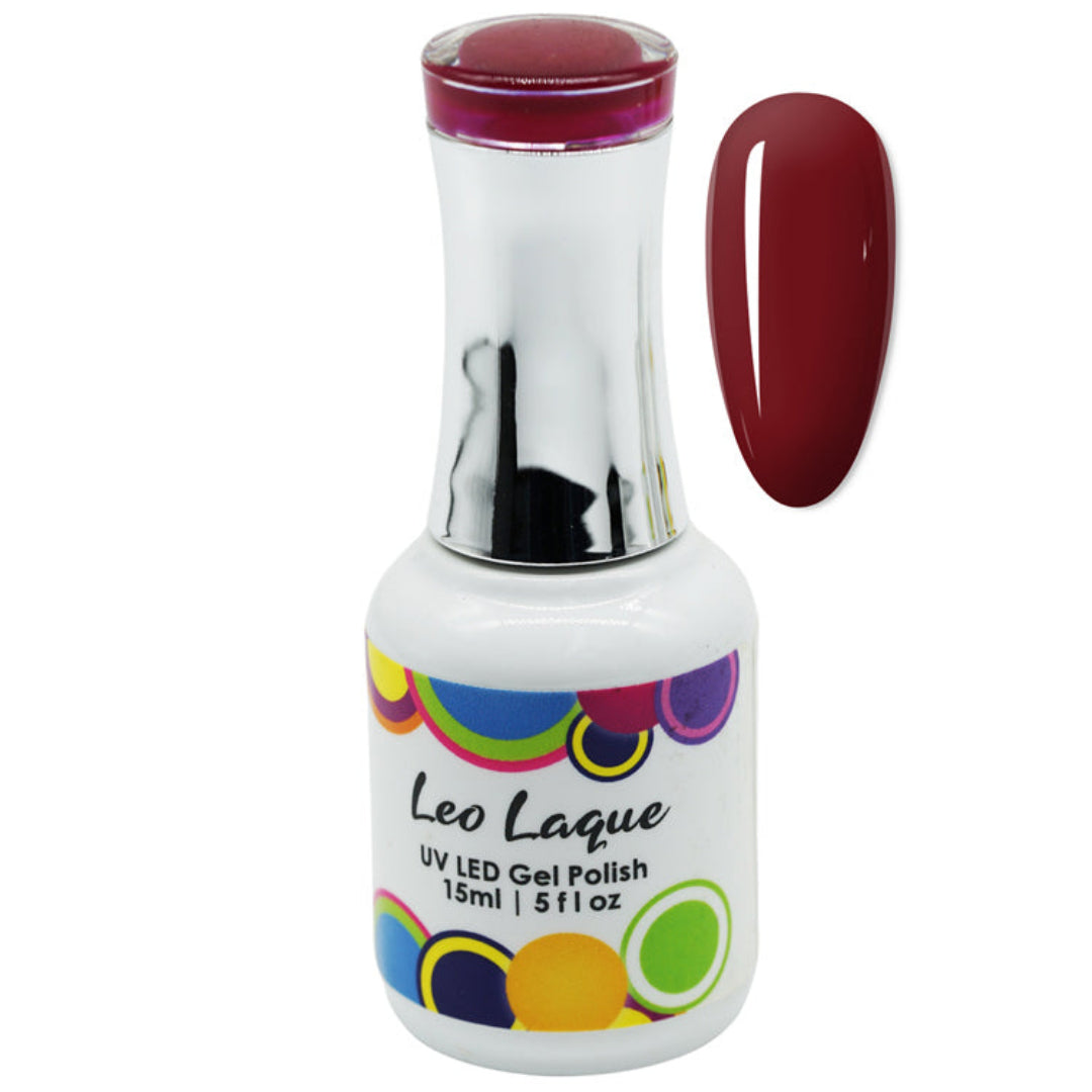 A bottle of Leo Lague UV LED Gel Polish with a white label and colorful polka dots, shown next to a vertical oval swatch of the deep burgundy-red polish color on a white background.